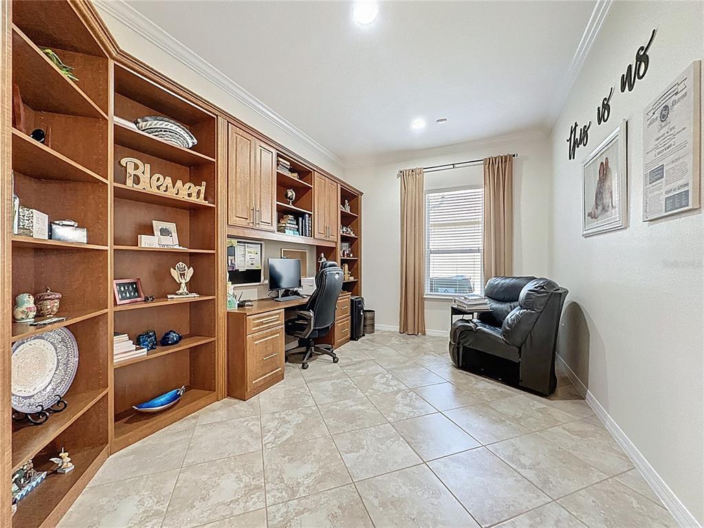 168 Silver Maple Road Groveland, FL 34736 - Photo 41 of 71 a living room with furniture cabinets and a window
