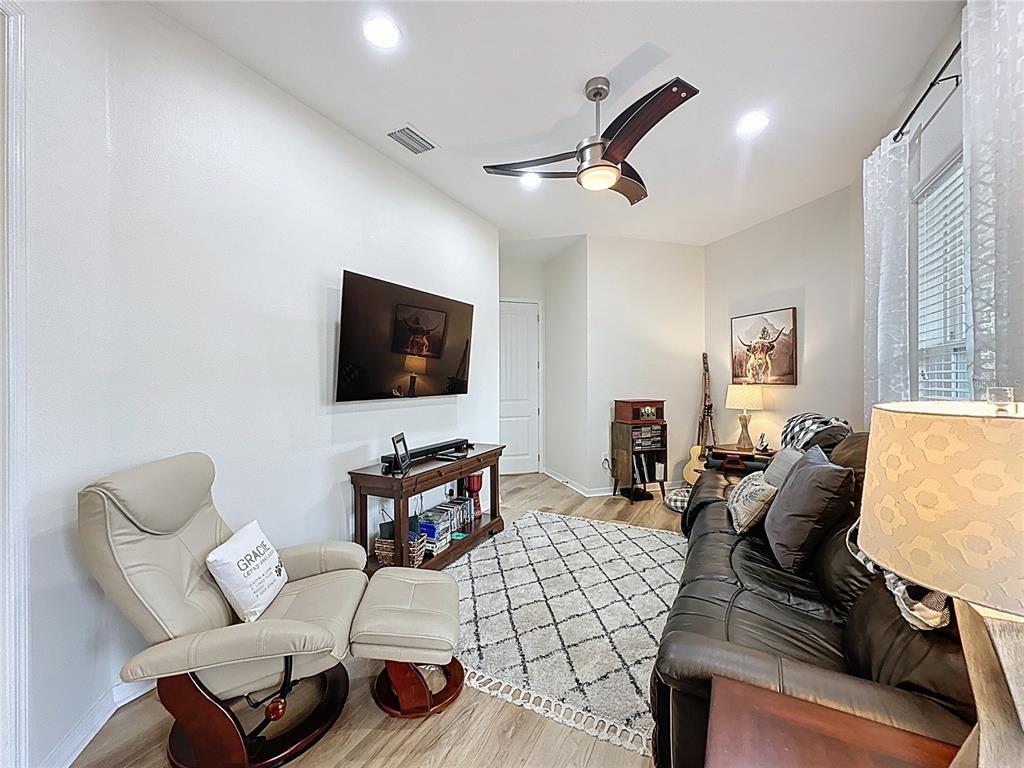 168 Silver Maple Road Groveland, FL 34736 - Photo 43 of 71 a living room with furniture and a flat screen tv