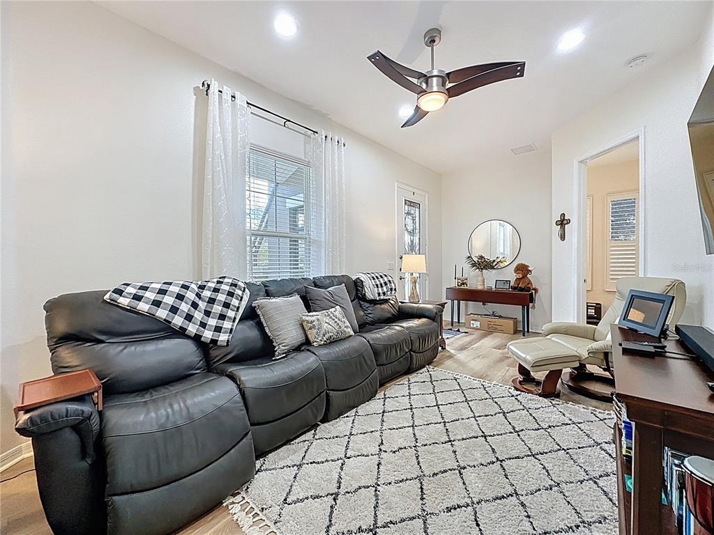 168 Silver Maple Road Groveland, FL 34736 - Photo 44 of 71 a living room with furniture and a ceiling fan