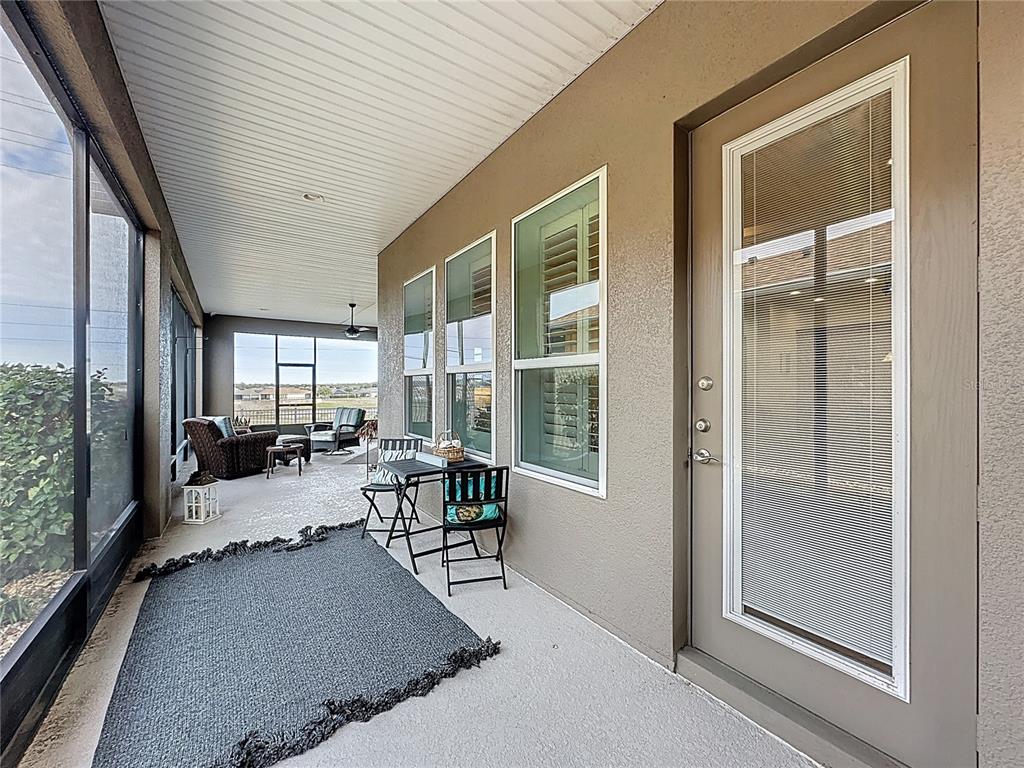 168 Silver Maple Road Groveland, FL 34736 - Photo 45 of 71 a dining hall with stainless steel appliances granite countertop a couch and a large window with garden view