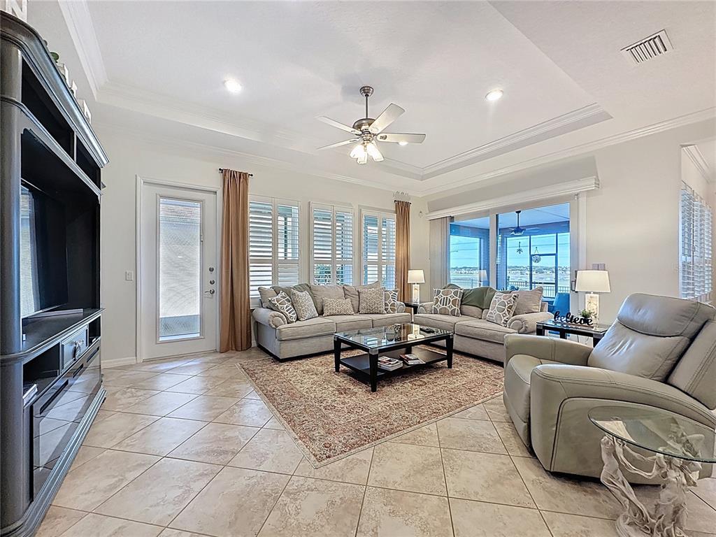 168 Silver Maple Road Groveland, FL 34736 - Photo 10 of 71 a living room with furniture ceiling fan and a window