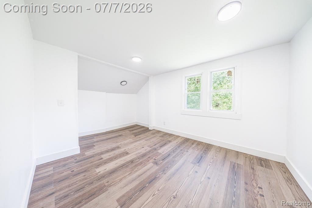 18486 Trinity Street Detroit, MI 48219 - Photo 7 of 19 Bright interior space featuring wood-finish flooring, white walls, dual windows, recessed lighting, and white baseboards