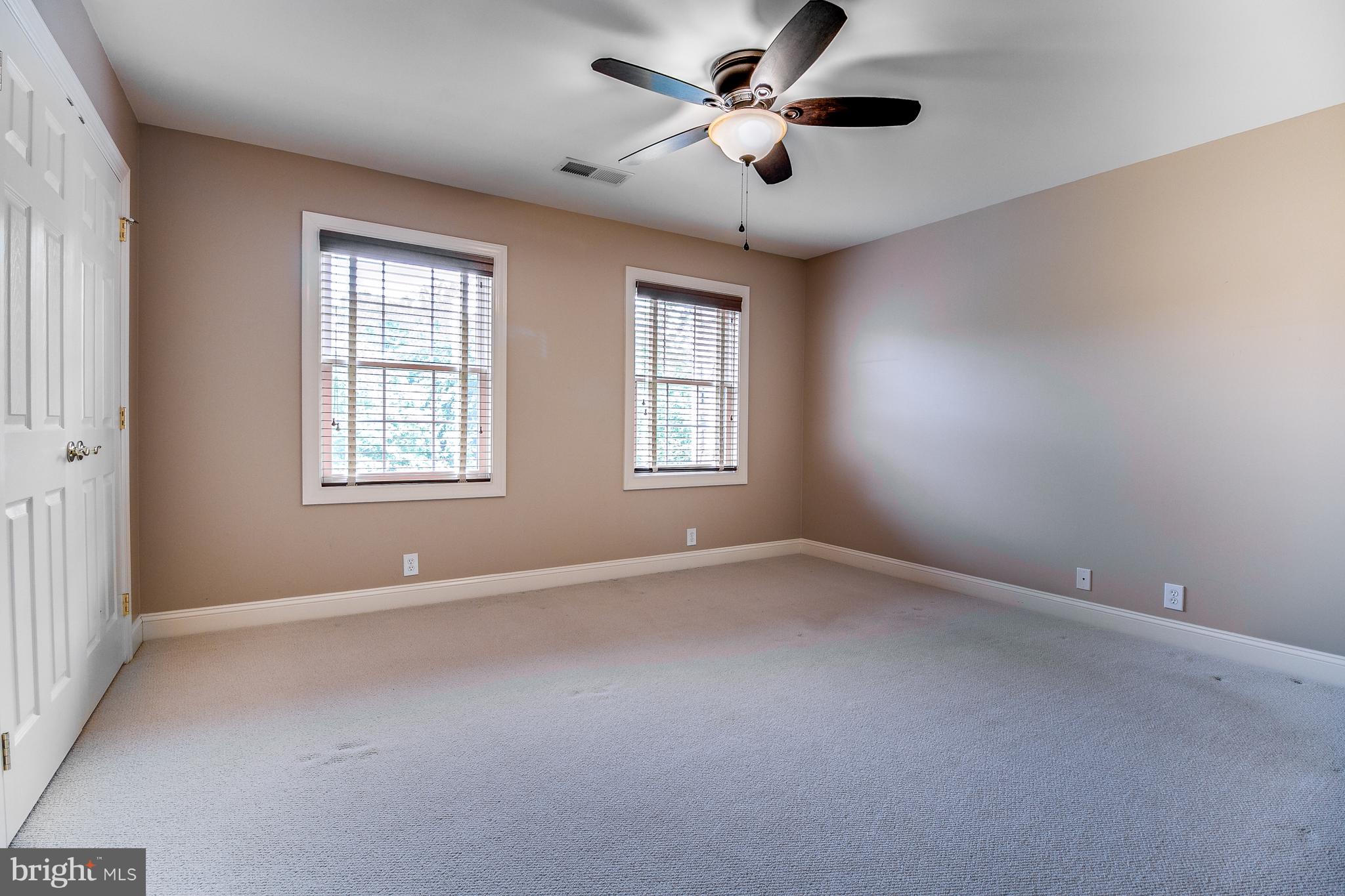 206 Fern Ridge Landenberg, PA 19350 - Photo 22 of 34 an empty room with chandelier fan and windows