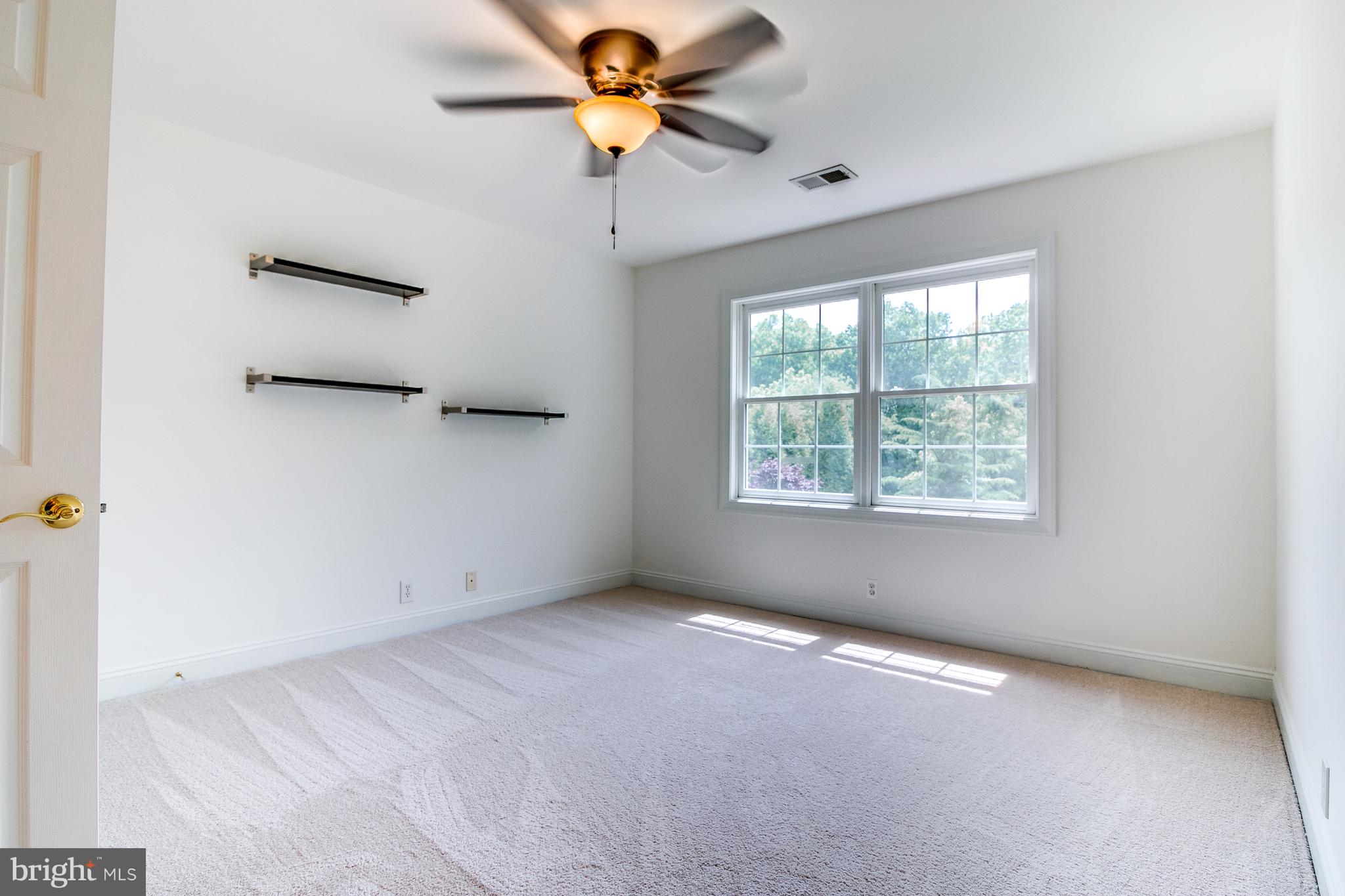 206 Fern Ridge Landenberg, PA 19350 - Photo 23 of 34 an empty room with a window and a ceiling fan