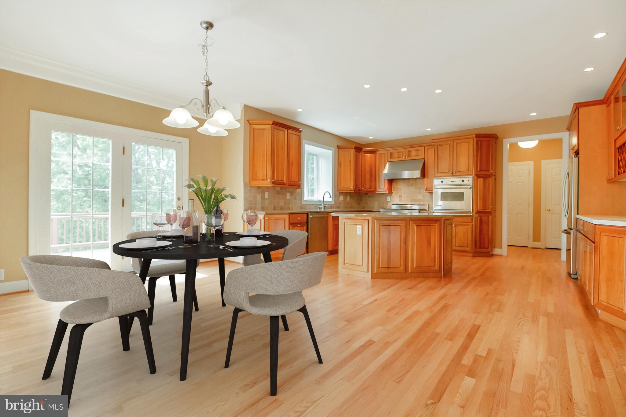 206 Fern Ridge Landenberg, PA 19350 - Photo 5 of 34 a kitchen with stainless steel appliances granite countertop a stove a refrigerator a kitchen island with a dining table and chairs