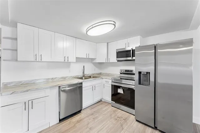 a kitchen with a sink stove and refrigerator