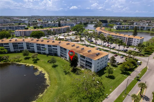 an aerial view of a house with a lake