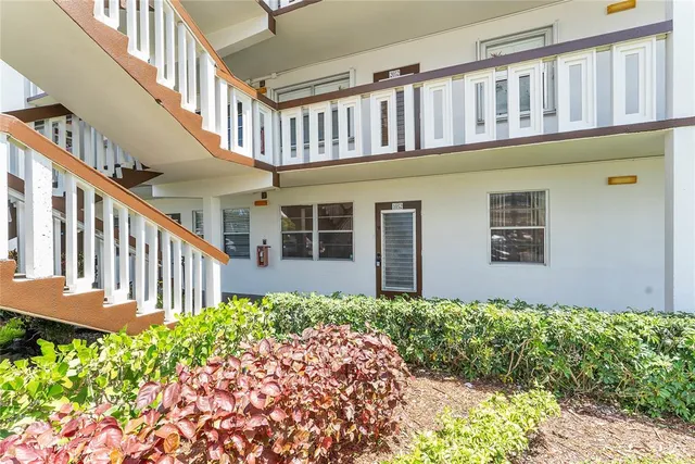 a front view of a house with a flower plants