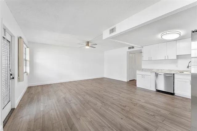 a view of a kitchen with wooden floor and a kitchen