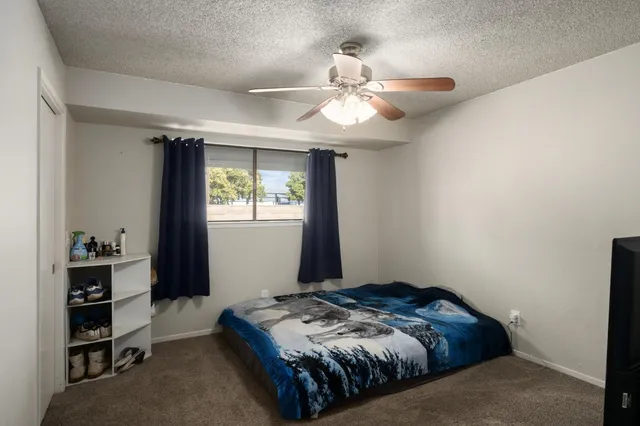 a bedroom with a bed and a window