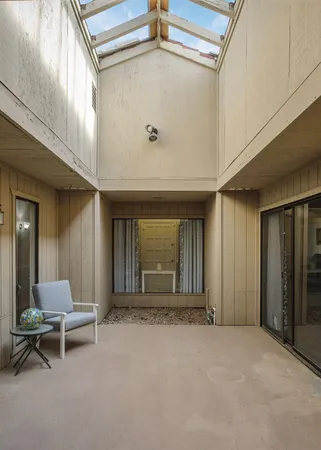a view of a livingroom with furniture and a window