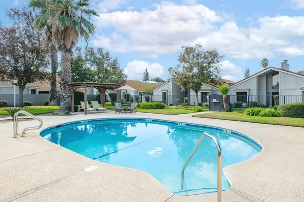a view of swimming pool with outdoor seating and yard