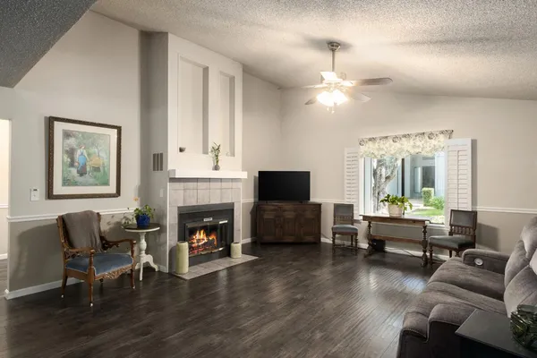 a living room with furniture fireplace and window