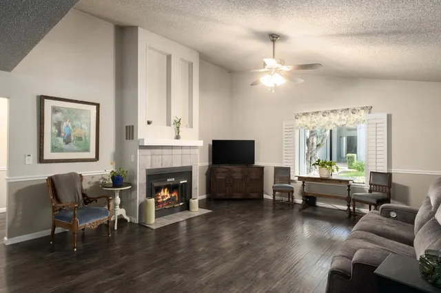 a living room with furniture fireplace and window