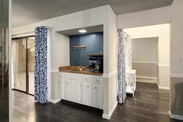 a room with a wooden floor and a view of bathroom