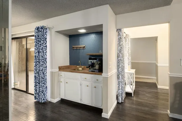 a room with a wooden floor and a view of bathroom