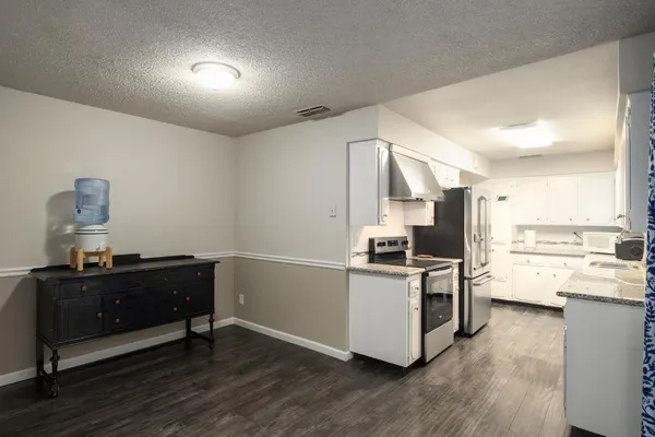 a kitchen with a stove and a refrigerator
