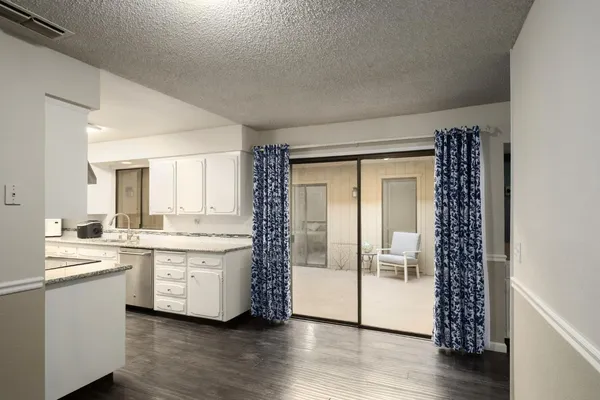 a large white kitchen with a large window