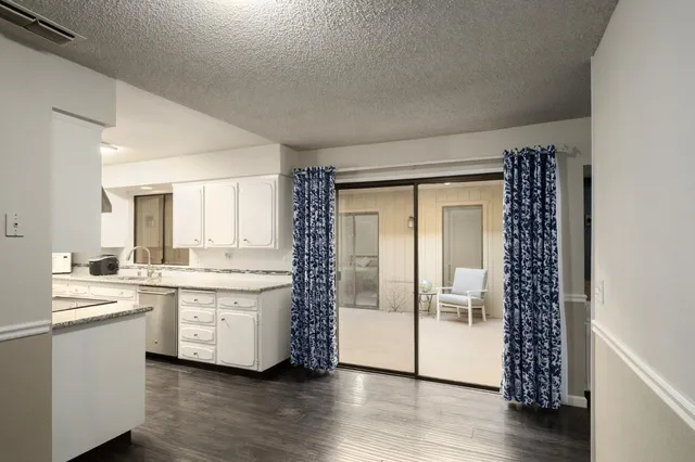 a large white kitchen with a large window