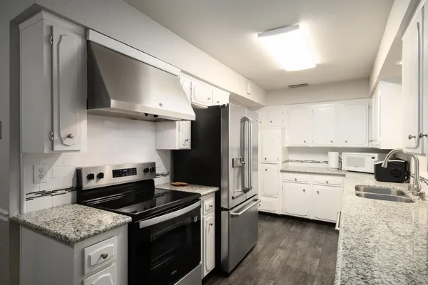 a kitchen with a stove oven and sink