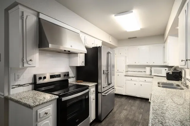 a kitchen with a stove oven and sink