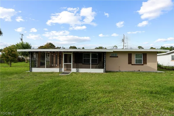 a view of a house with a backyard
