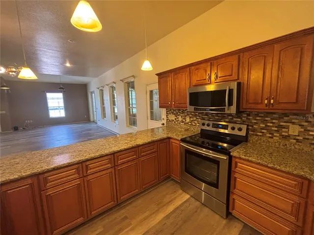 a kitchen with stainless steel appliances granite countertop a stove and a sink