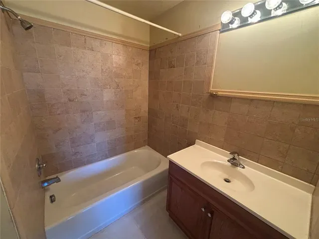 a view of a livingroom with wooden floor and a ceiling fan