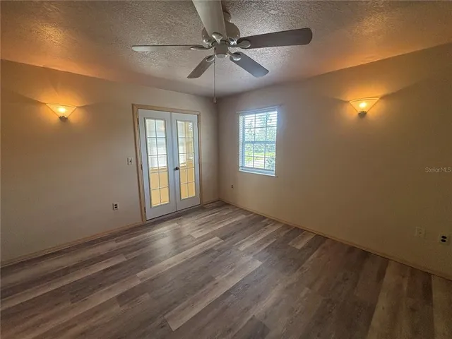 a bathroom with a granite countertop toilet and a sink
