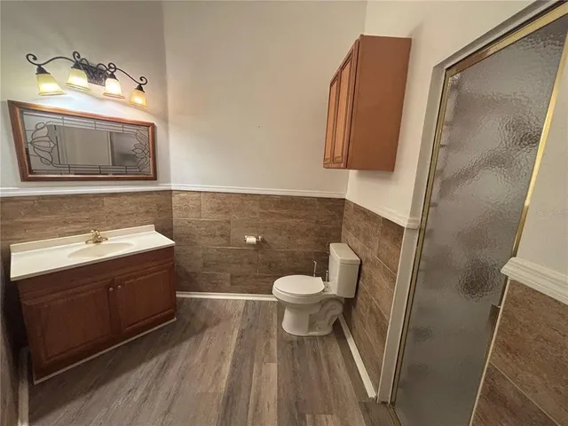 a bathroom with a sink toilet and shower