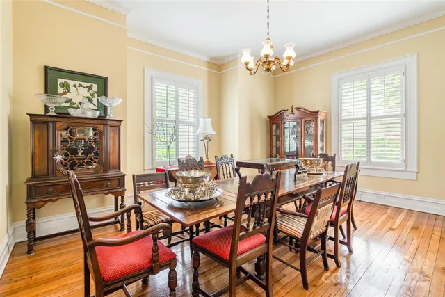 a view of a dining room with furniture wooden floor and chandelier