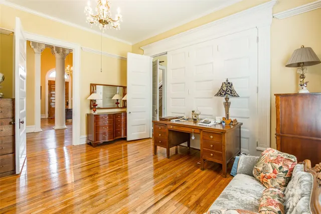 a bedroom with a bed and a chandelier