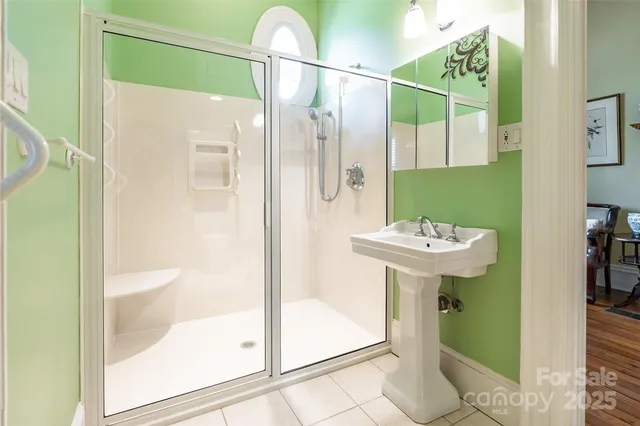 a bathroom with a sink a mirror and a shower