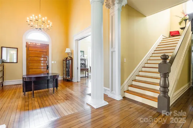 a view of a room with wooden floor and stairs