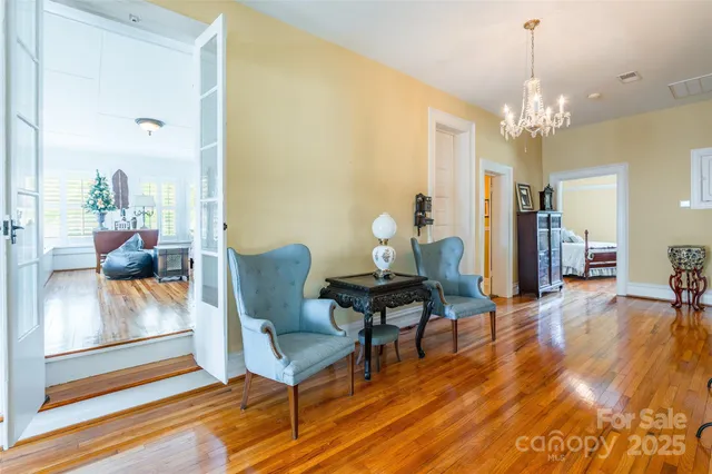 a living room with furniture and a chandelier