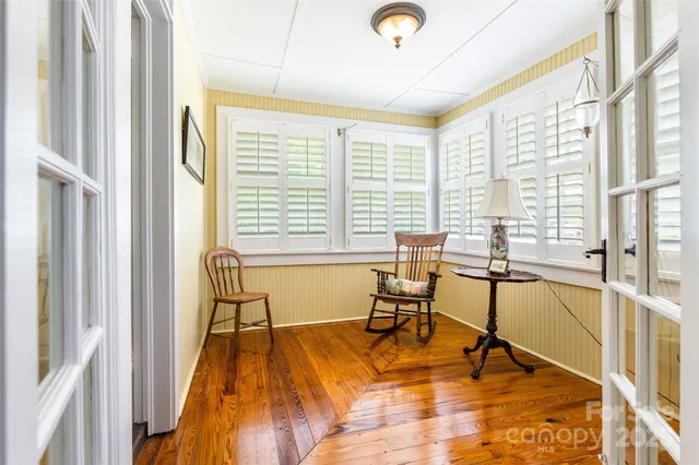 a view of a swimming pool with table and chairs