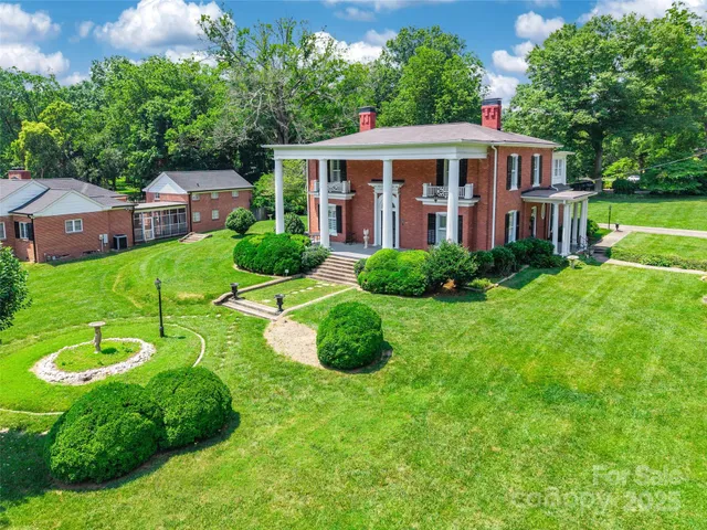 a view of a house with backyard sitting area and garden