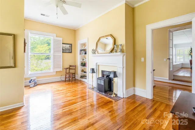 a view of a livingroom with a fireplace a sink and dining room view