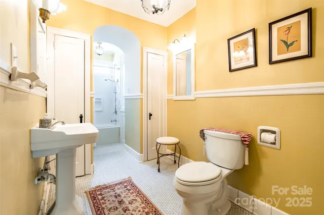 a bathroom with a toilet a sink and a mirror