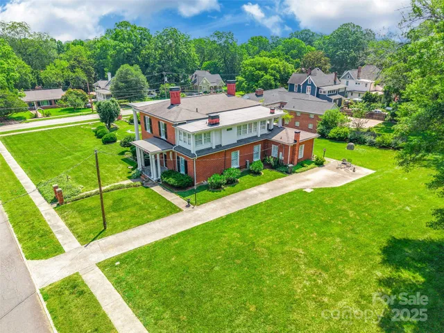 an aerial view of a house with a big yard