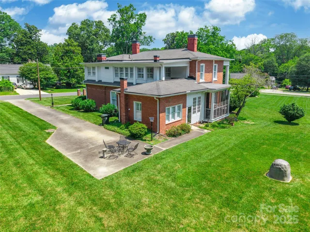a front view of house with a garden