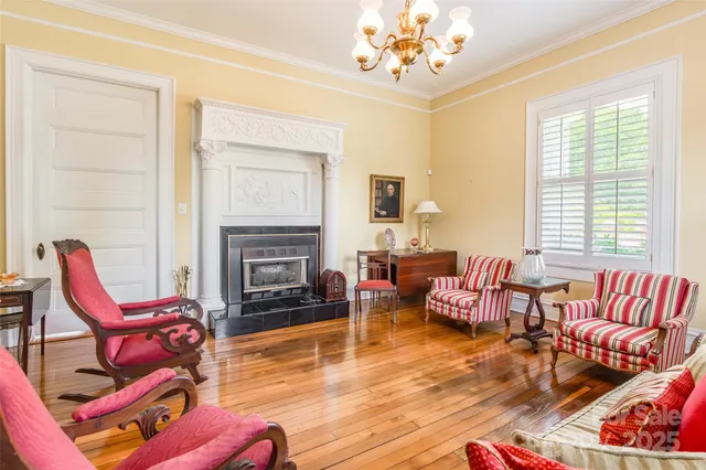 a living room with furniture fireplace and a large window