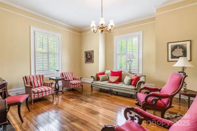 a living room with furniture and a chandelier
