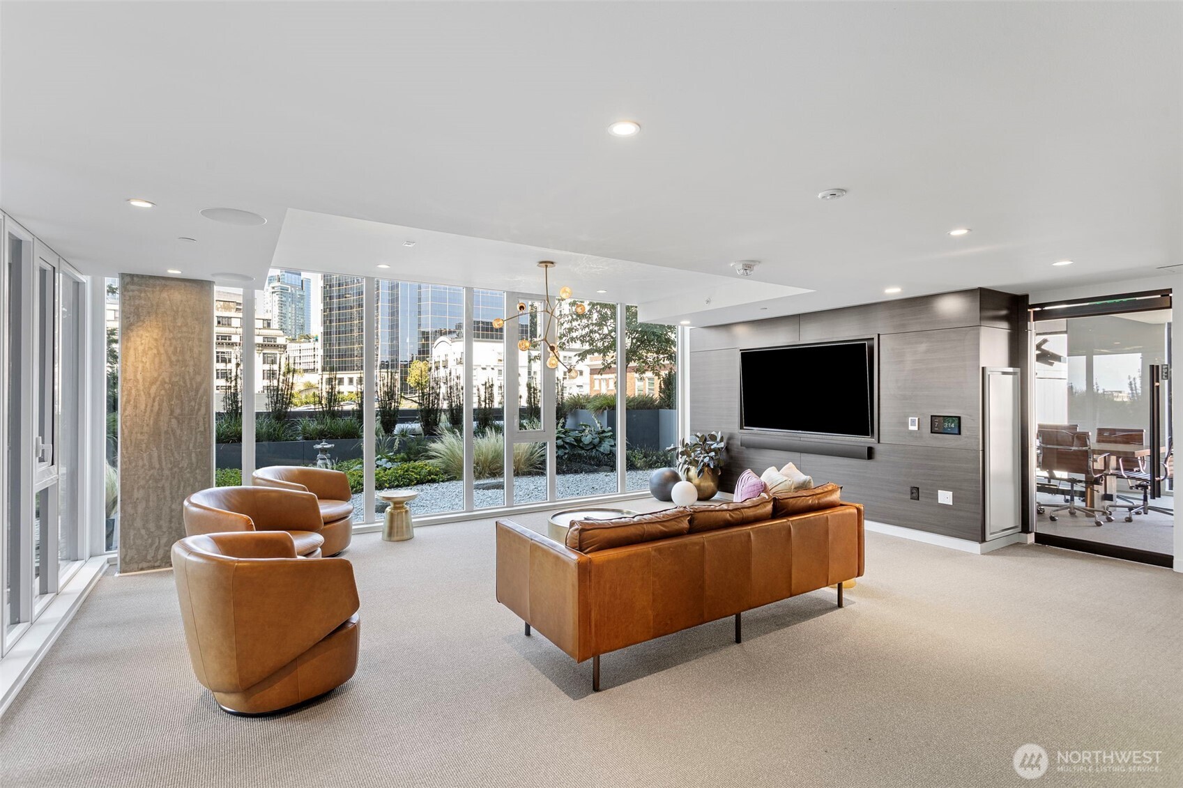450 South Main Street, Unit 1005 Seattle, WA 98104 - Photo 12 of 33 a living room with furniture a flat screen tv and a large window
