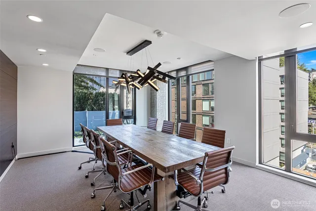 a very nice looking living room with furniture and floor to ceiling windows