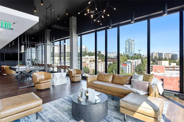 a large kitchen with sink a refrigerator and wooden floor