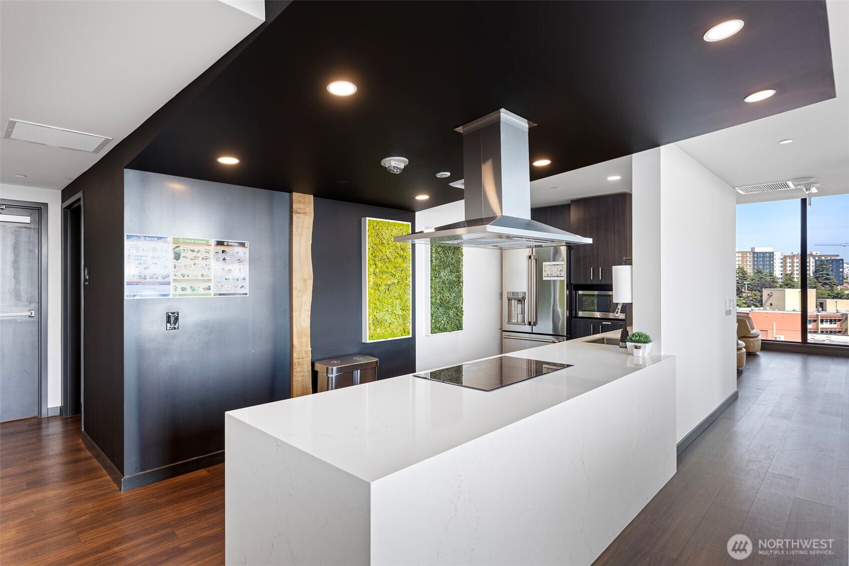 450 South Main Street, Unit 1005 Seattle, WA 98104 - Photo 19 of 33 a large kitchen with sink a refrigerator and wooden floor