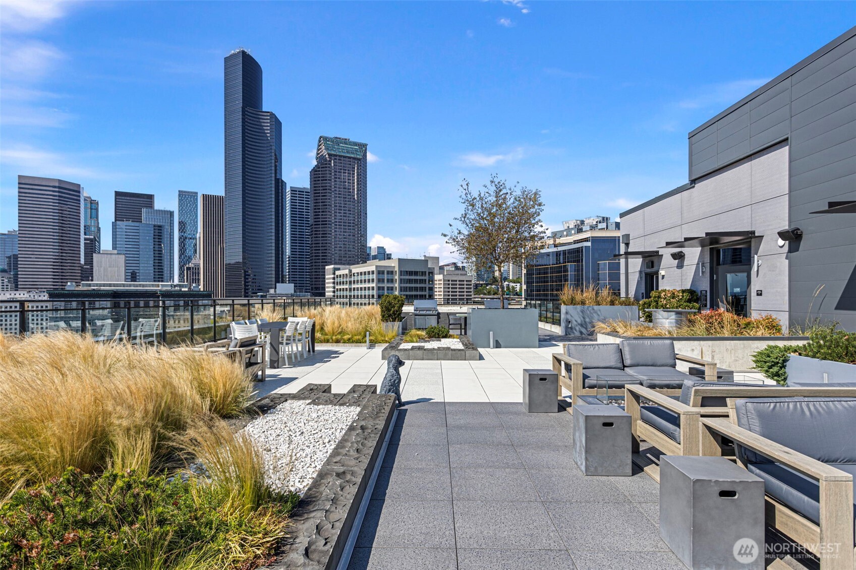 450 South Main Street, Unit 1005 Seattle, WA 98104 - Photo 21 of 33 a view of a swimming pool with outdoor seating and plants