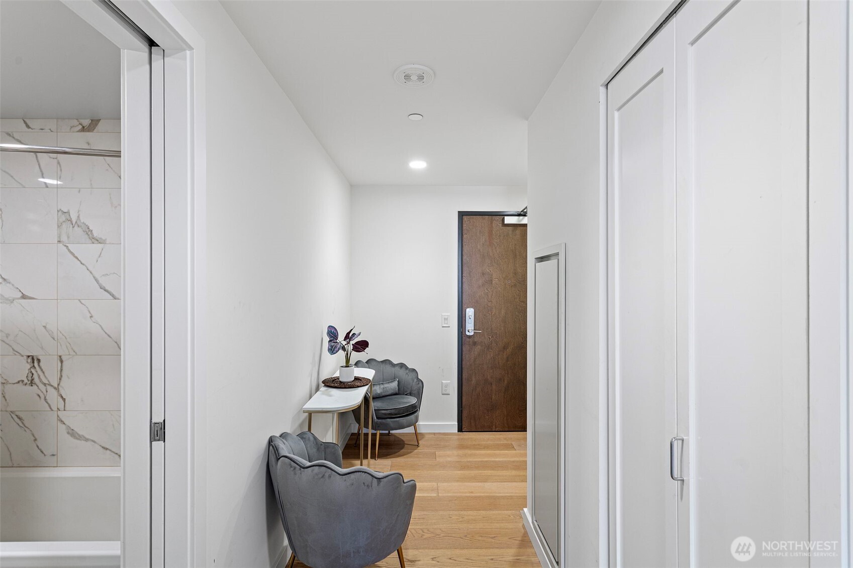 450 South Main Street, Unit 1005 Seattle, WA 98104 - Photo 25 of 33 a view of a hallway with couch and white cabinet