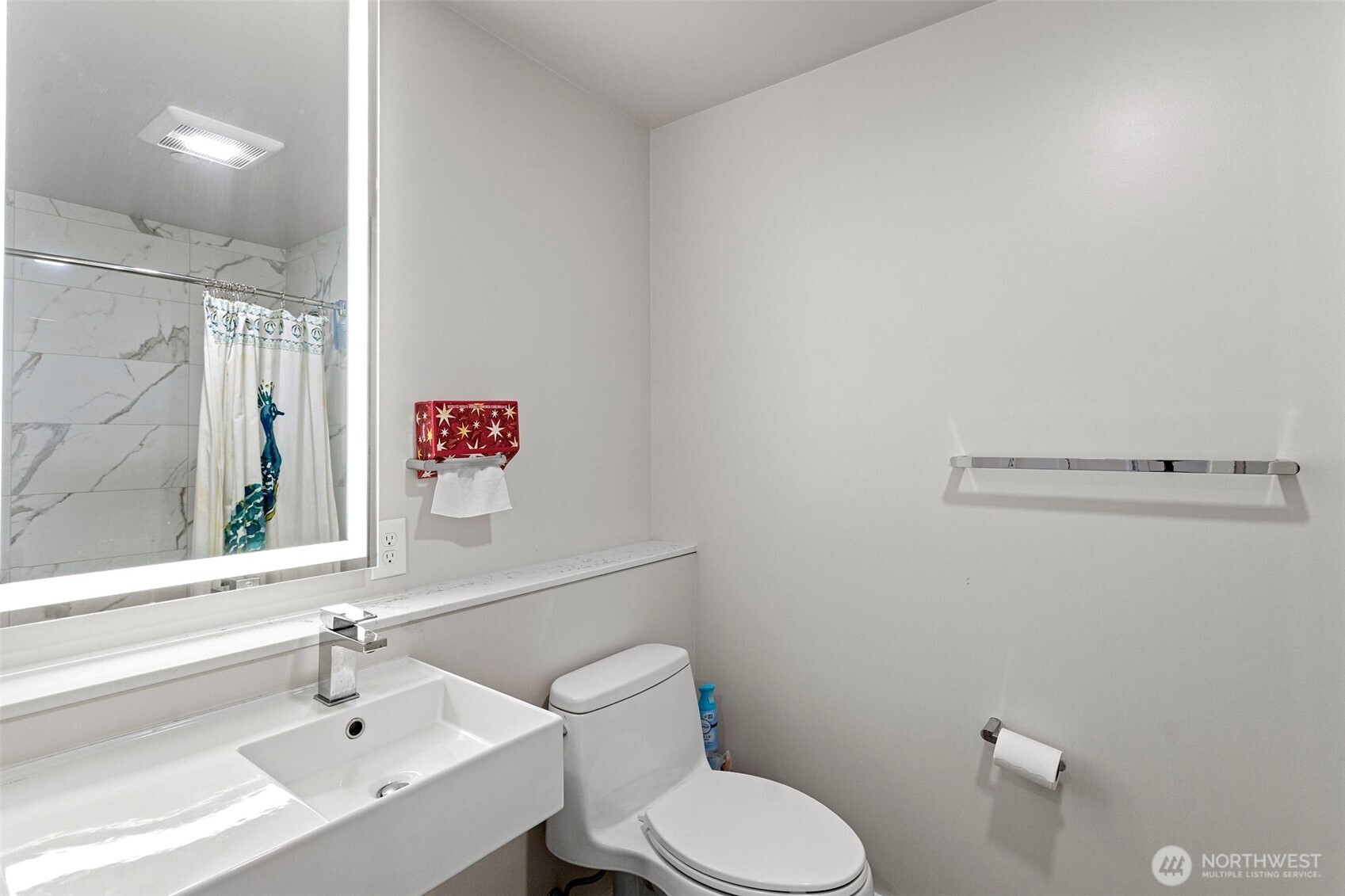 450 South Main Street, Unit 1005 Seattle, WA 98104 - Photo 27 of 33 a bathroom with a sink a toilet and a mirror